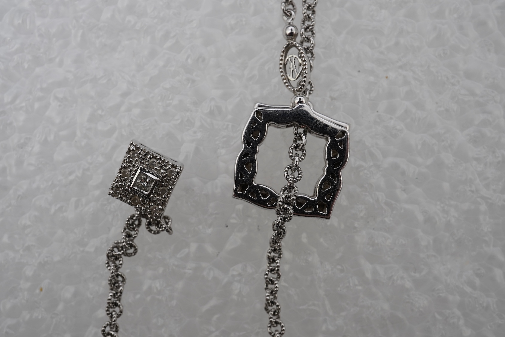 A diamond lariat necklace